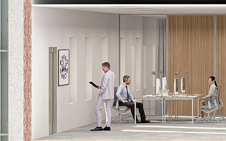 Das Bild zeigt drei Personen in einem Büroraum.